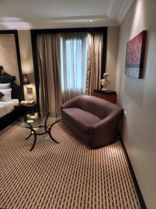 a living room with a couch in a hotel room at St. Mark's Hotel in Bangalore