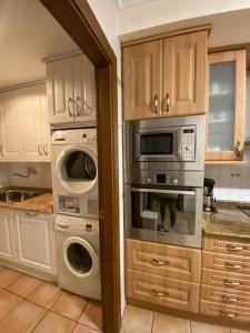 a kitchen with two ovens and a microwave at Casa los 8 caños in Ezcaray