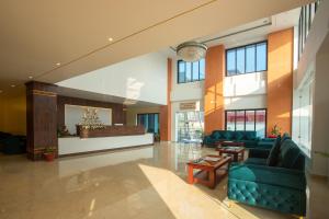 a lobby with blue couches and a bar in a building at Bhairahawa Garden Resort in Rummindei