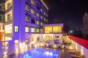 a hotel with a swimming pool in front of a building at Bhairahawa Garden Resort in Lumbini