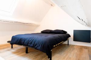 a bedroom with a bed and a tv in a attic at CARMEN in Serris