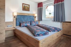 a bed with pillows on it in a room at Klammgut in Wagrain