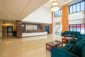 a lobby with blue couches and tables and a counter at Bhairahawa Garden Resort in Lumbini