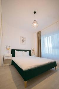 a bedroom with a large bed and a window at House by the Lake 7 in Bucharest