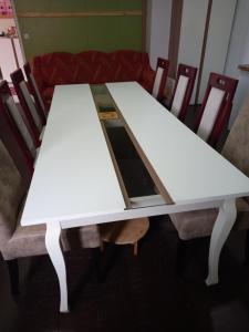 a table with two white tables and chairs at Arthur 3 in Brčko