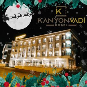 a hotel with a christmas sign in front of it at Kanyonvadi Hotel in Karabuk