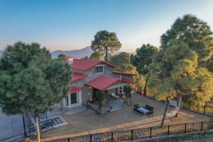 an aerial view of a house with a red roof at SaffronStays The Perch in Kasauli