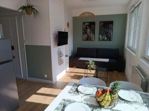 a living room with a table with a bowl of fruit on it at chez Clem in Calais