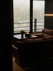 a living room with a couch and a table and a window at Diamond Hotel in Amman