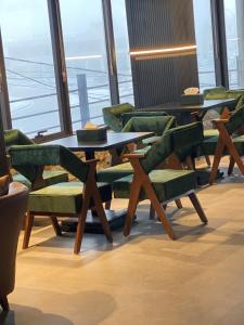 a table and chairs in a room with a window at Diamond Hotel in Amman