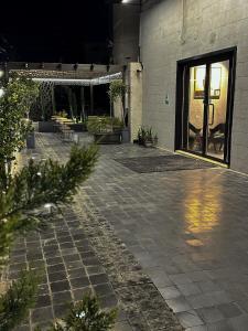 a patio with trees and a door to a building at Diamond Hotel in Amman