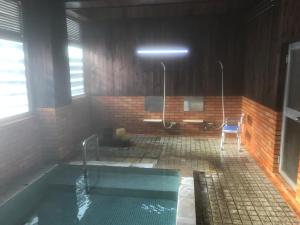 uma casa de banho com banheira num edifício em Yamatoya em Nozawa Onsen