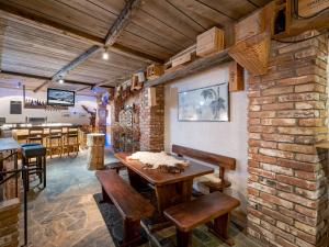 a dining room with a brick wall and a table and chairs at Hotel Alpenhof in Westendorf