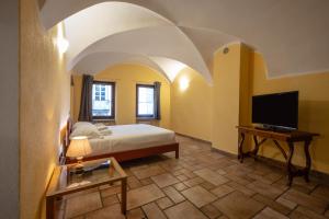 Televízia a/alebo spoločenská miestnosť v ubytovaní Inn Aosta Apartments
