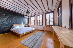 a bedroom with a bed and a chalkboard wall at The Kosk -5Br Villa with Turkish Bath- City Centre in Istanbul