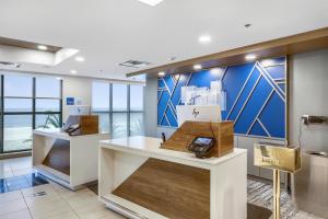 a lobby of a store with blue and white walls at Holiday Inn Express - Gulfport Beach, an IHG Hotel in Gulfport