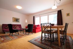 a living room with a table and chairs and a couch at Appartements Maria Stewart by Schladming-Appartements in Schladming