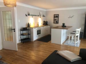 a kitchen and living room with a table and a counter at Alte Glaserei Travemünde in Travemünde