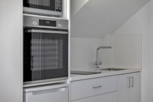 a kitchen with a stainless steel oven and a microwave at Phaedrus Living Alkminis Seaview Suites Pantai in Paphos City