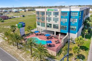 an aerial view of a hotel with a pool at Holiday Inn Express - Gulfport Beach by IHG in Gulfport