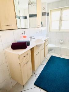 a bathroom with a sink and a mirror at Ferienwohnung Alpensymphonie mit 110 m2 und sonnigem Balkon in Burgberg