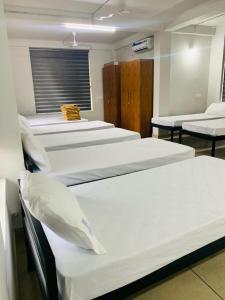 a row of beds in a hospital room at Regalia Wayanad in Kalpetta