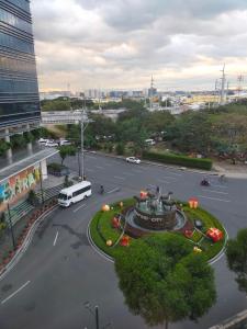 a city intersection with a bus on a street at Rosecondotel in Manila