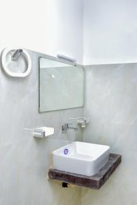 a white sink in a bathroom with a mirror at Muthu Villa 94 Midigama in Ahangama East