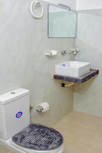 a bathroom with a toilet and a sink at Muthu Villa 94 Midigama in Ahangama East