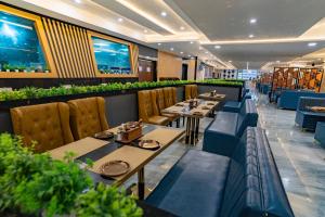 a dining room with tables and chairs at Essotto Recreation Hub in Bangalore