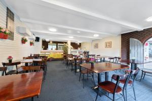 柏斯的住宿－Econo Lodge Rivervale，用餐室配有木桌和椅子