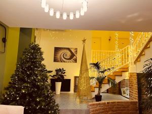 a christmas tree in a room with a staircase at Boutique Hotel Manufactura in Tbilisi City
