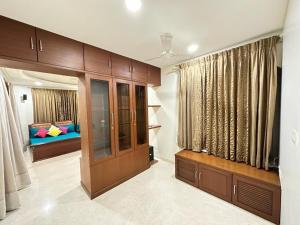 een woonkamer met houten kasten en een bank bij WHITEVILLA 5 ROOMS in Pune