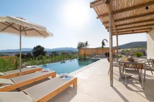 an outdoor patio with a view of a swimming pool at Massari Hills Luxury Living in Malona Village