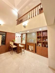 a large kitchen with a table and chairs at WHITEVILLA 5 ROOMS in Pune