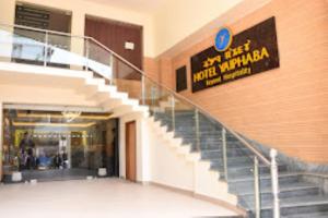 a staircase in a building with a sign on the wall at Hotel Yaiphabaa , Imphal in Imphal