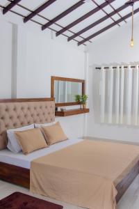 a bedroom with a large bed in a room at Muthu Villa 94 Midigama in Ahangama East