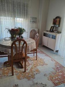 une salle à manger avec une table et des chaises ainsi qu'une cuisine dans l'établissement Hera Apartment, à Alexandroúpolis