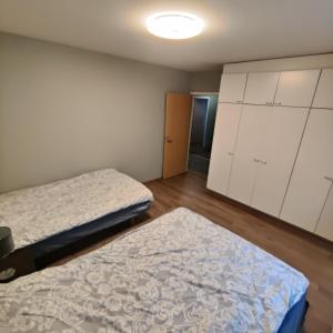 a small room with two beds and a closet at GREEN in Närpiö