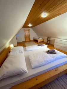 two beds in a room with a attic at Traditional deer Cabin with Sauna in Dolný Kubín