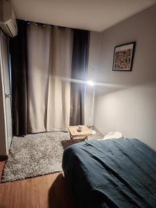 a bedroom with a bed and a table in front of a window at Urban Space Gangnam station in Seoul