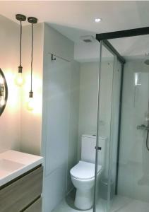 a white bathroom with a toilet and a shower at Estudio Pau @VALENCIAYOLE in Valencia