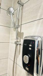 a shower head and a soap dispenser in a bathroom at STYLISH 1Bhk HEART OF THE CITY in Edinburgh