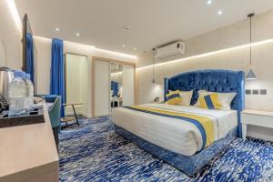 a hotel room with a large bed and a desk at Al Musafir Hotel in Riyadh +10 photos