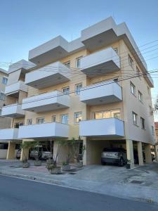 a building with balconies on the side of a street at Princess Residence in Ayios Dhometios