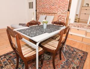a dining room table with two chairs on a rug at Dream duplex near the Royal Palace - city center in Brussels