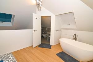 a bathroom with a white tub and a sink at Dream duplex near the Royal Palace - city center in Brussels