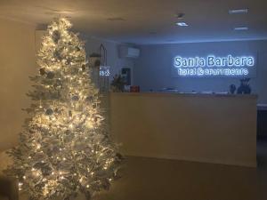 a christmas tree in the lobby of a santa barbara hospital at Santa Barbara hotel & apartments in Bellaria-Igea Marina