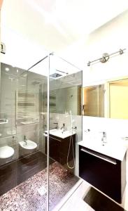 a bathroom with two sinks and a glass shower at Hotel Cuba Aeroport Restaurant in Rimini