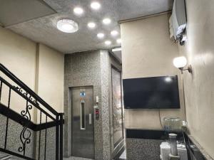 a bathroom with a elevator and a television on the wall at Hotel Seref in Yalova